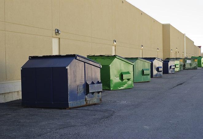 a row of industrial dumpsters at a construction site in Aplington